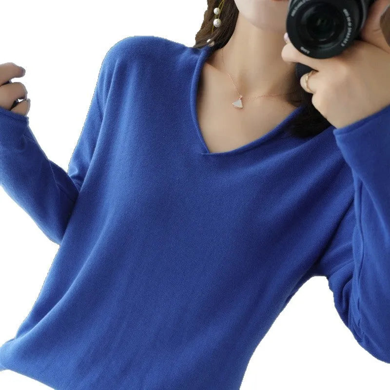 Women's V-neck long sleeve knit top in turmeric colour on a hanger