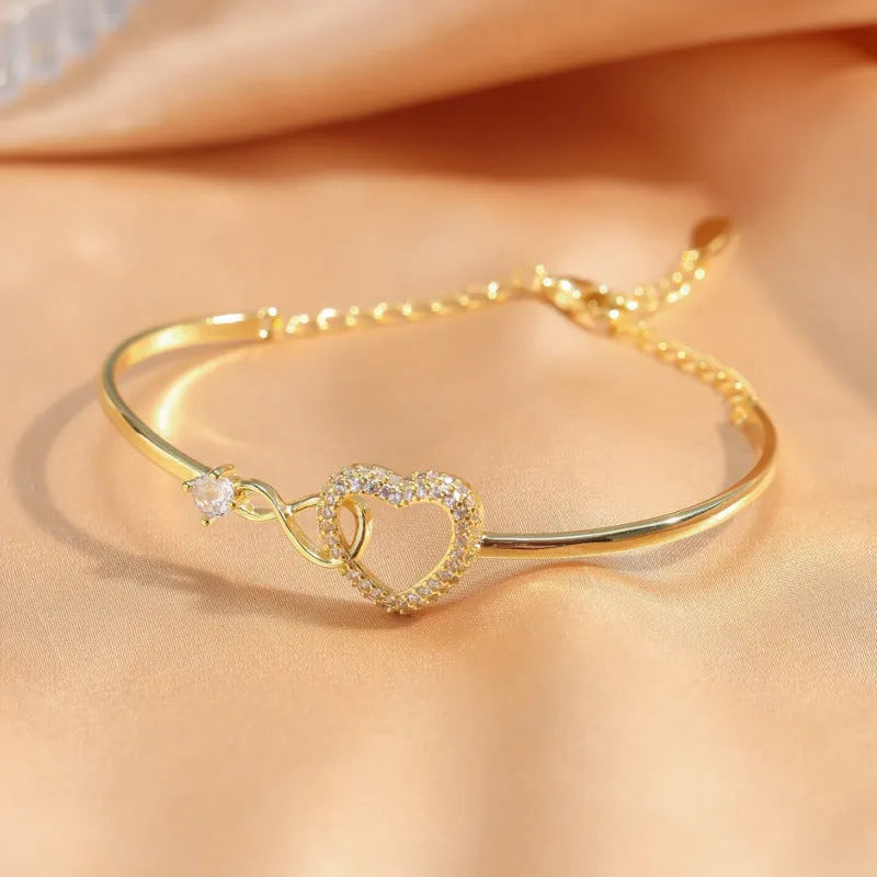 Hollow zircon loving heart opening bracelet in silver finish on copper base with electroplating