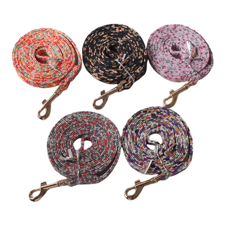 Cloth dog harness and leash set shown in various colours including a floral print, for small dogs.