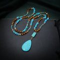 Turquoise blue necklace with water drop shaped pendant on ball bead chain