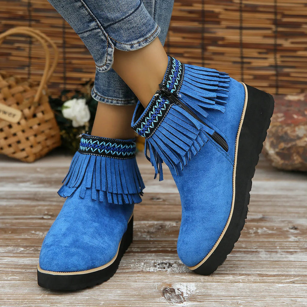 Women's dark brown suede wedge ankle boots with side zipper and tassel detail on a thick rubber sole.