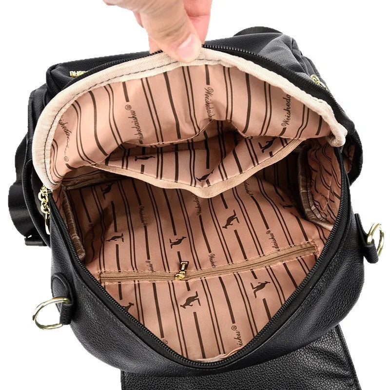 Genuine leather women's student travel backpack with pendant in beige colour, featuring covered outer pocket and belt decoration
