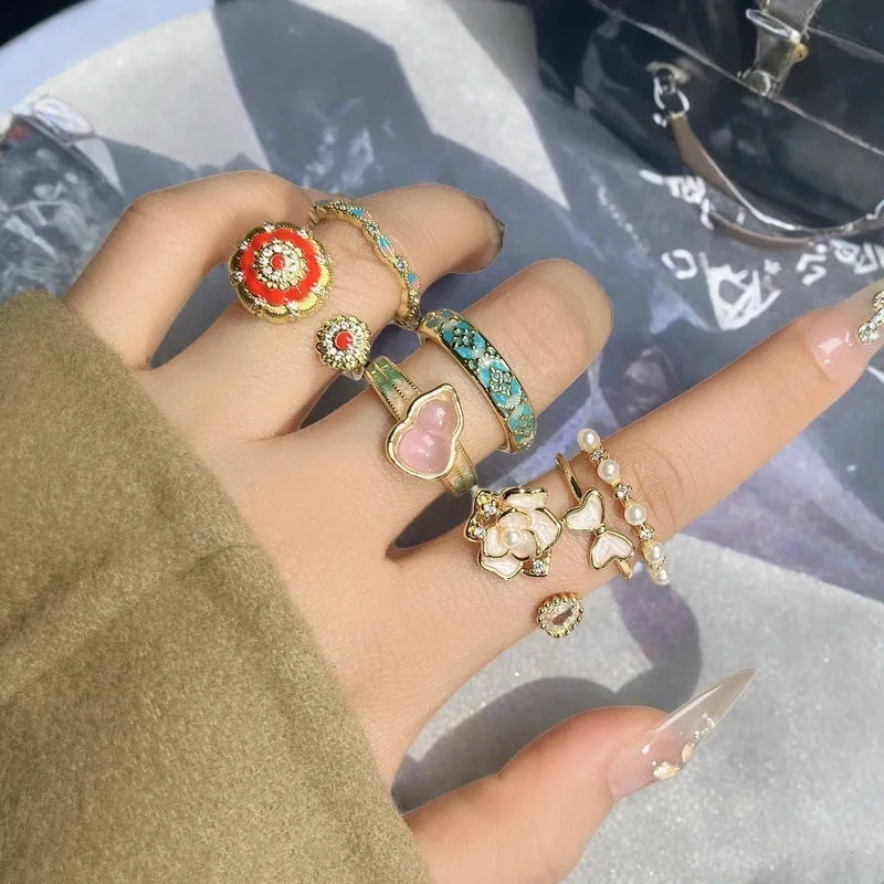 Adjustable vintage-style copper ring with gourd, flower, and bow design featuring inlaid zircon stones.