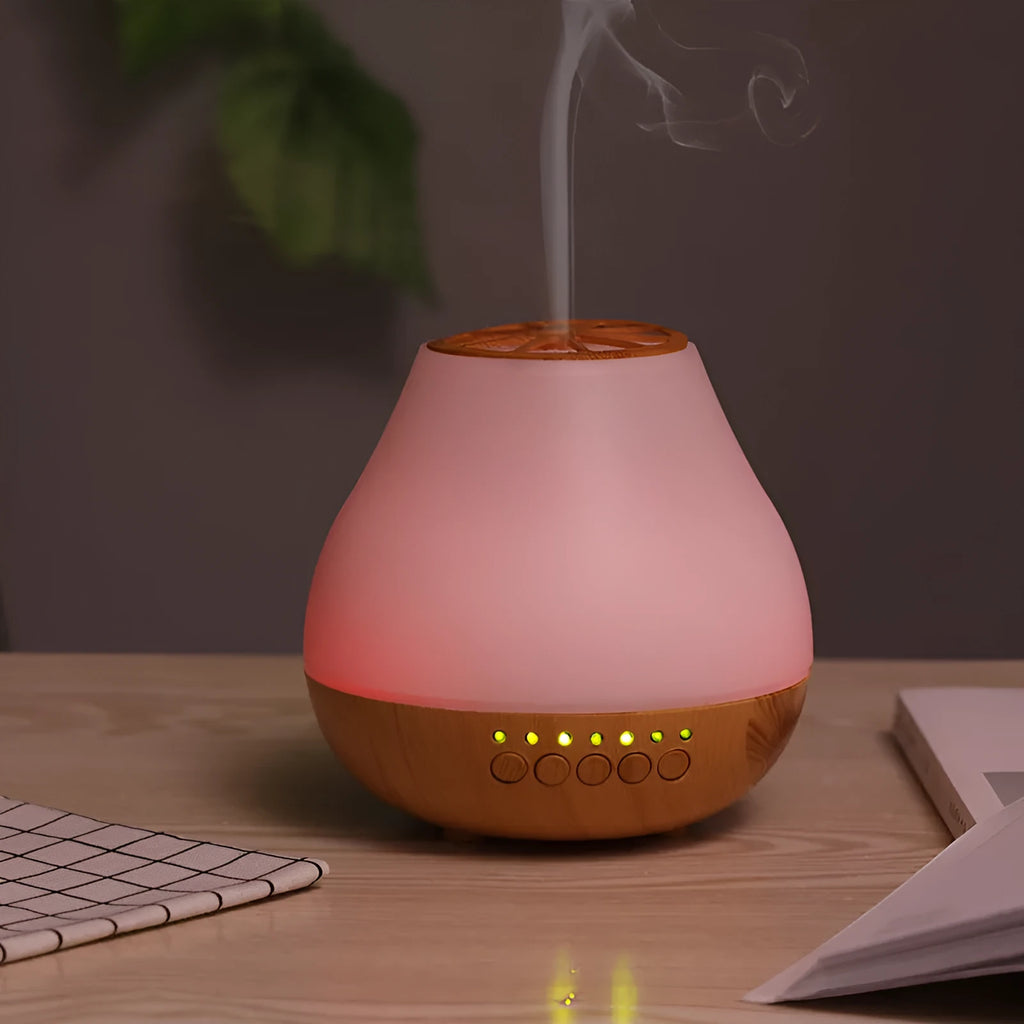 USB ultrasonic aroma diffuser with wood grain finish and colourful light on a wooden desk