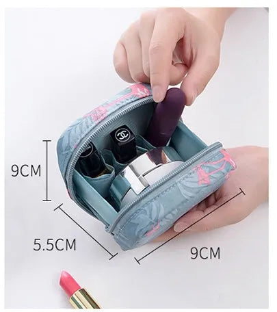 Blue cloth cube makeup storage bag with zipper open showing interior.