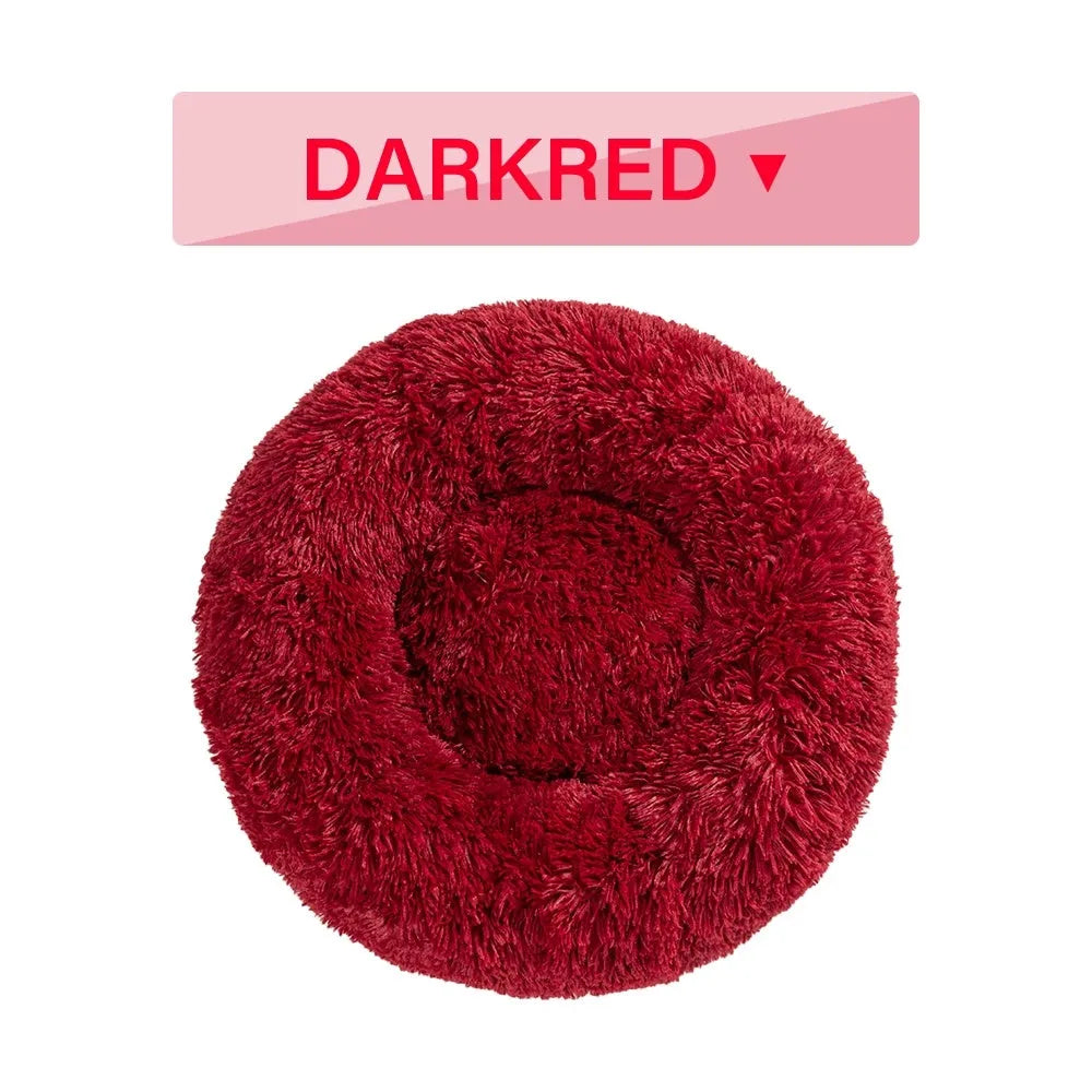 Fluffy donut-shaped pet bed in long plush material, showing raised edge and central well.