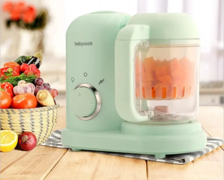 Green baby food processor with steamer and blender functions, double mixing blades