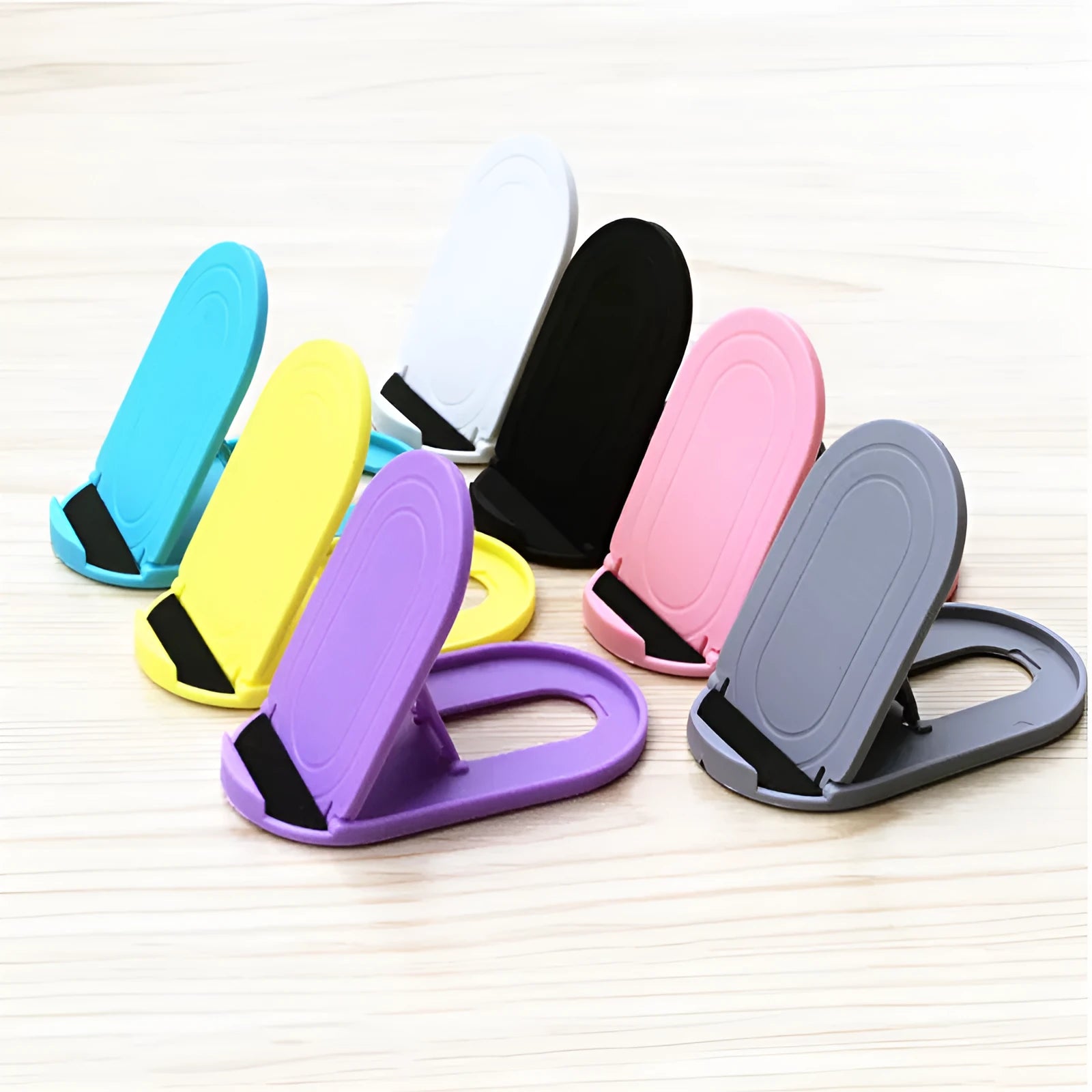 Plastic lazy bracket mobile phone stand in one of six colour options: black, blue, grey, pink, white, or yellow.