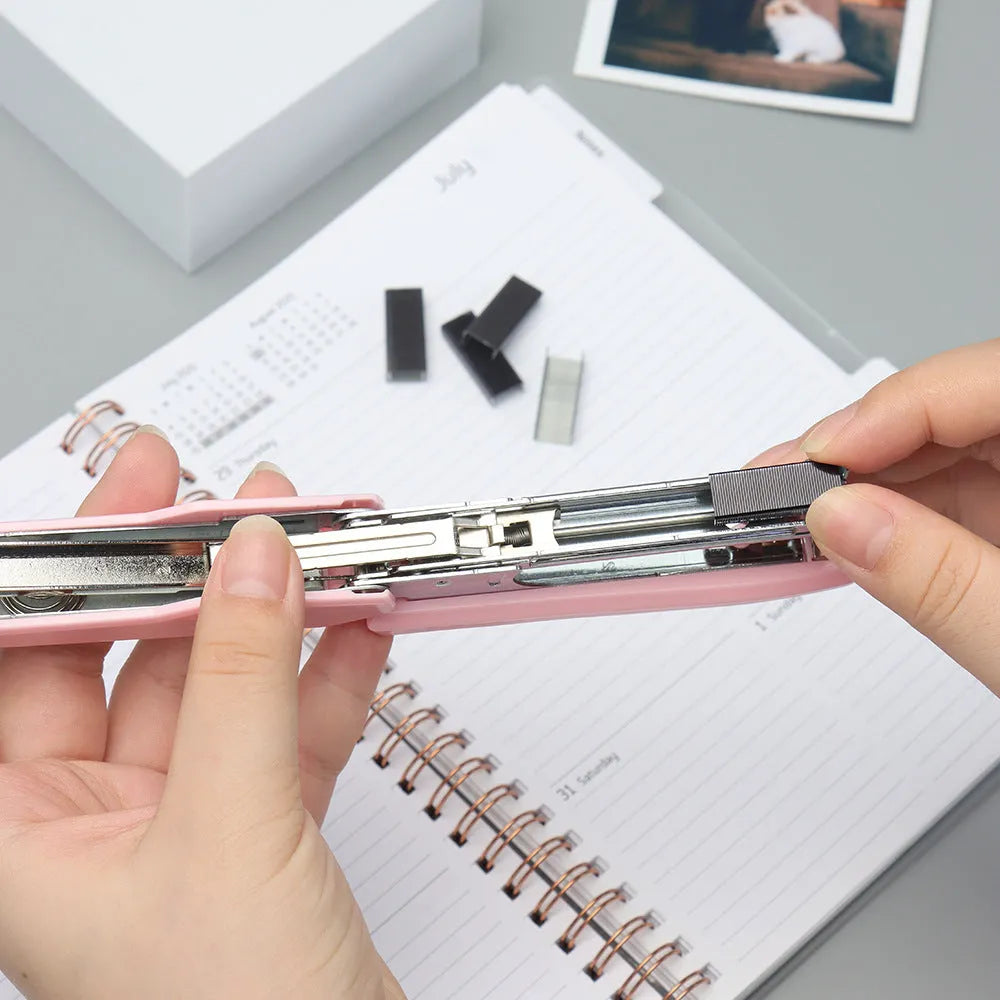 Box of 1000 metal office staples showing black, purple, rose gold, and rose red colour options.
