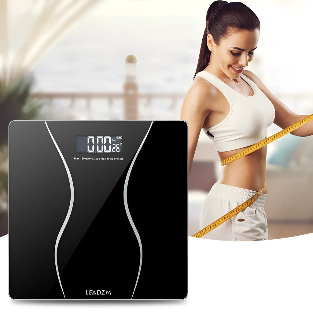 Black digital electronic bathroom scale on a tiled floor showing a weight reading.