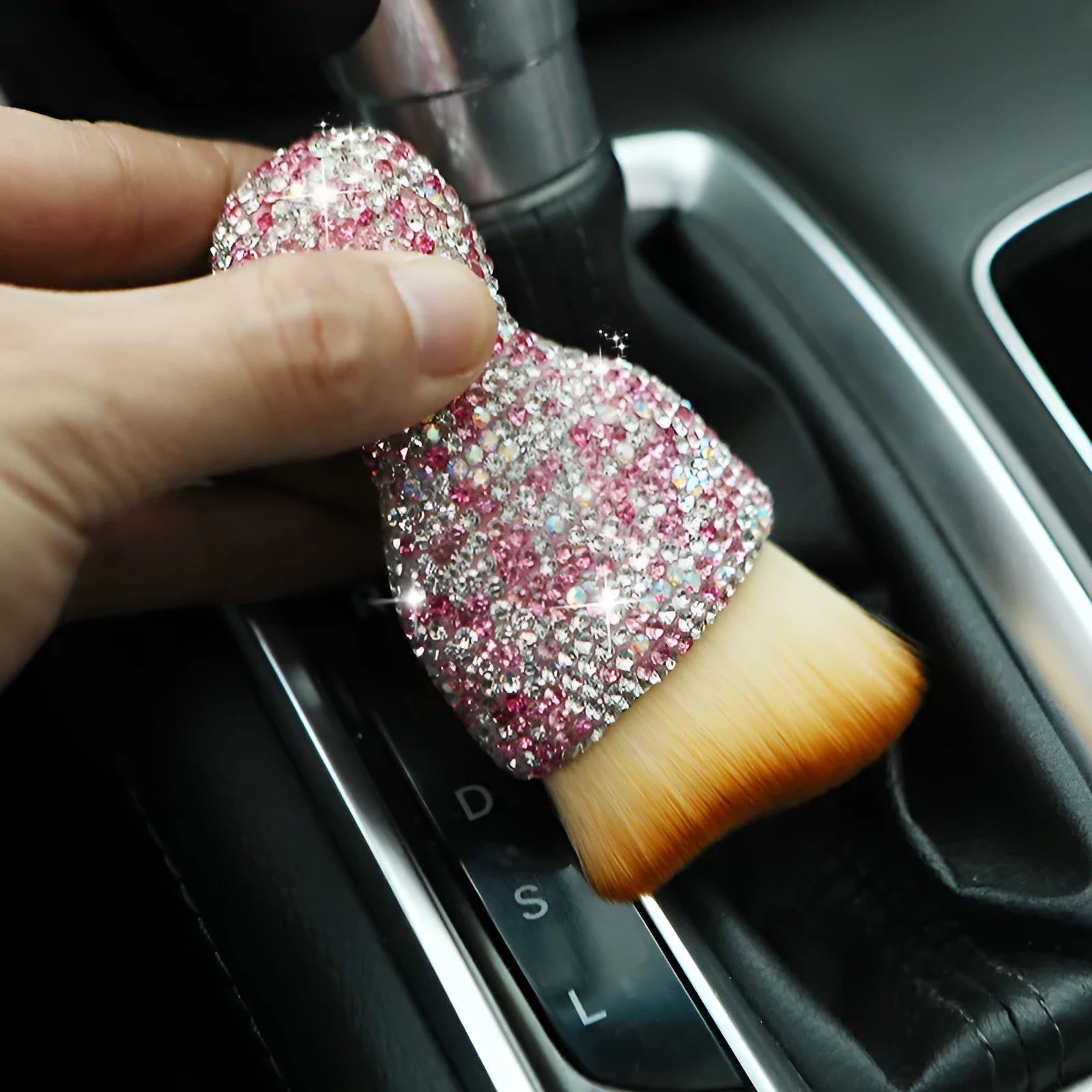 White PVC car interior cleaning brush on a car dashboard, showing its compact size and soft bristles.