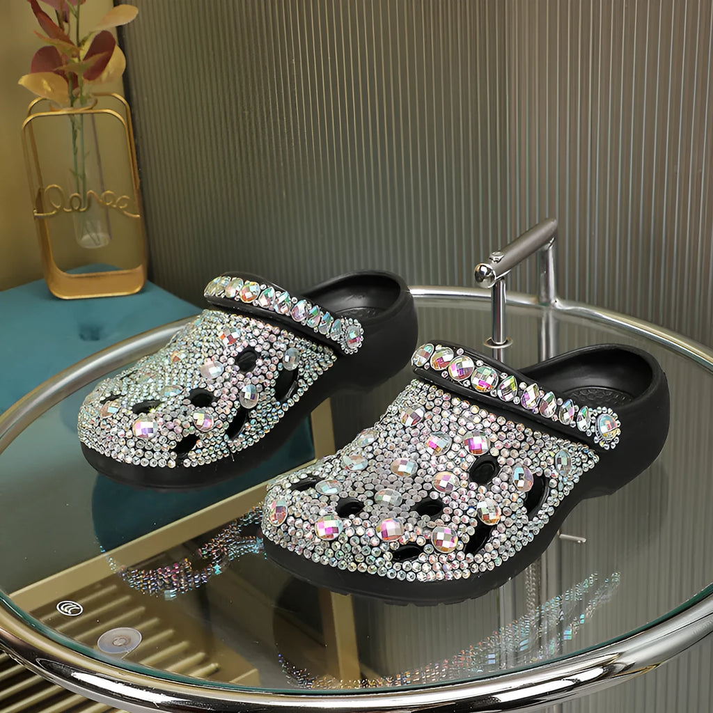 Black women's platform sandals with rhinestone decoration and a holey EVA upper.