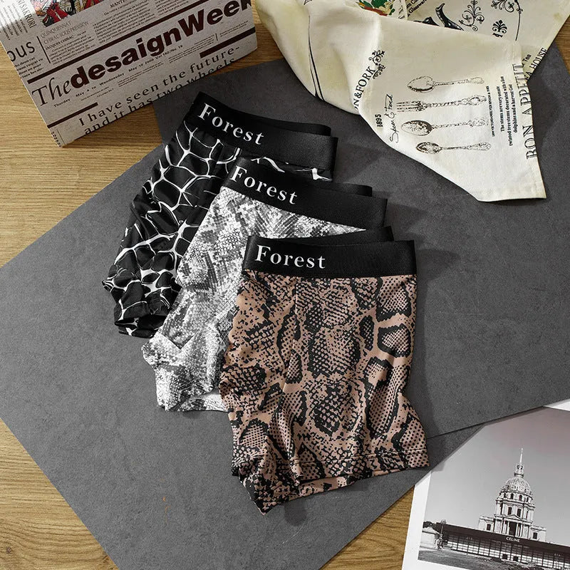 Men's thin loose knitted polyester boxer shorts in black, grey, and brown colours on a mid-waist model.