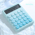 Dopamine gradient colour desktop calculator in violet, pink, blue, or green on a desk.