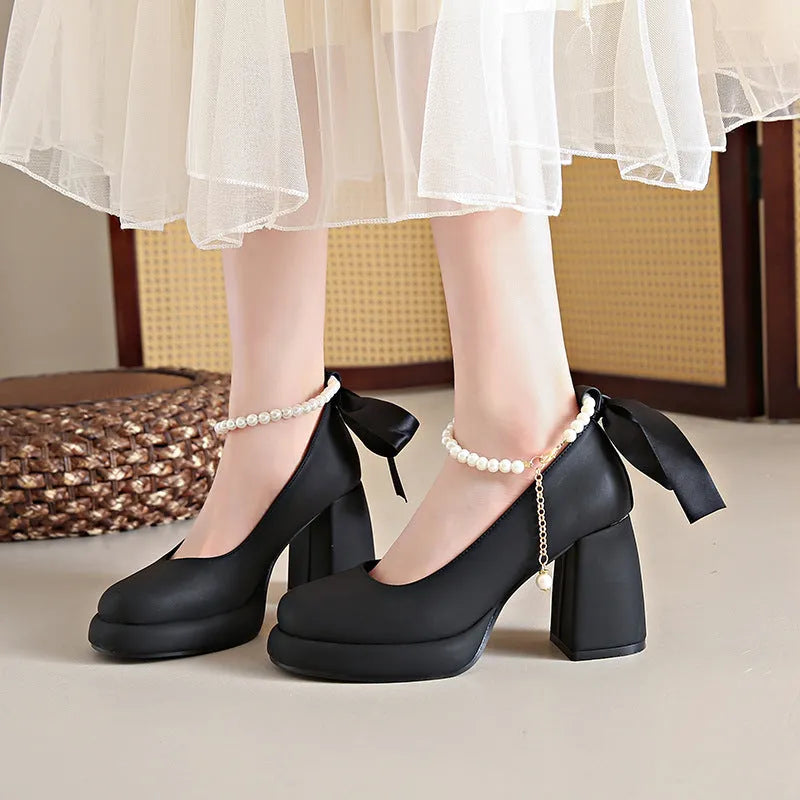 Women's beige Mary Jane shoes with chunky heel and ankle-strap buckle on a neutral background