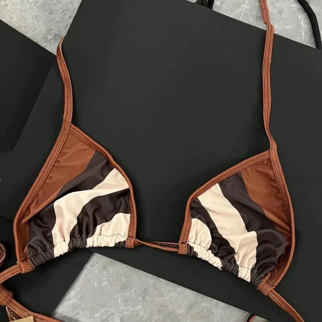 Women's black and white floral bikini set with split briefs on a beach