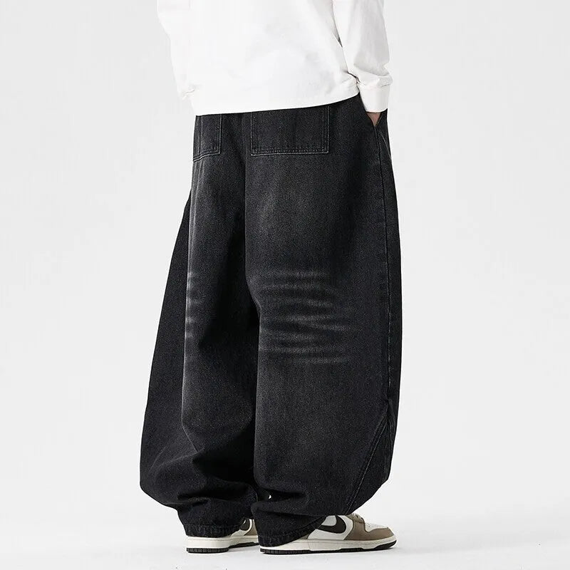 Men's plus size baggy jeans in light blue denim with wide straight legs and a low waist.