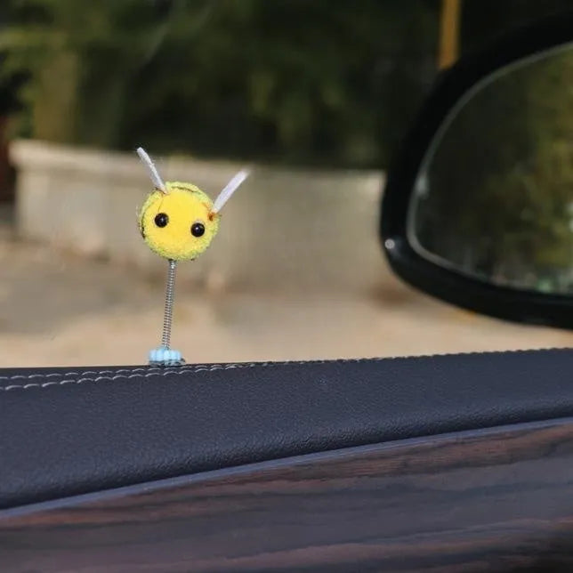Cartoon-style little bee car decoration made from a soft fur ball, shown next to a ruler showing its 3cm size.