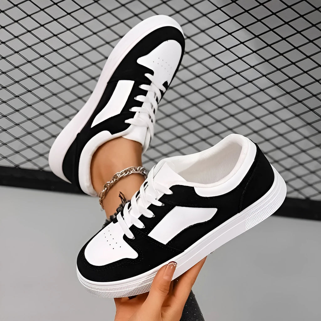 Black women's casual sports shoes with round toe and lace-up front, featuring a low top and flat rubber sole.