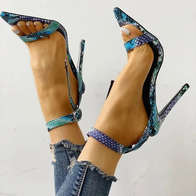 Blue women's high heels with serpentine design, hollow out details, buckle fastening, and pointed toe.