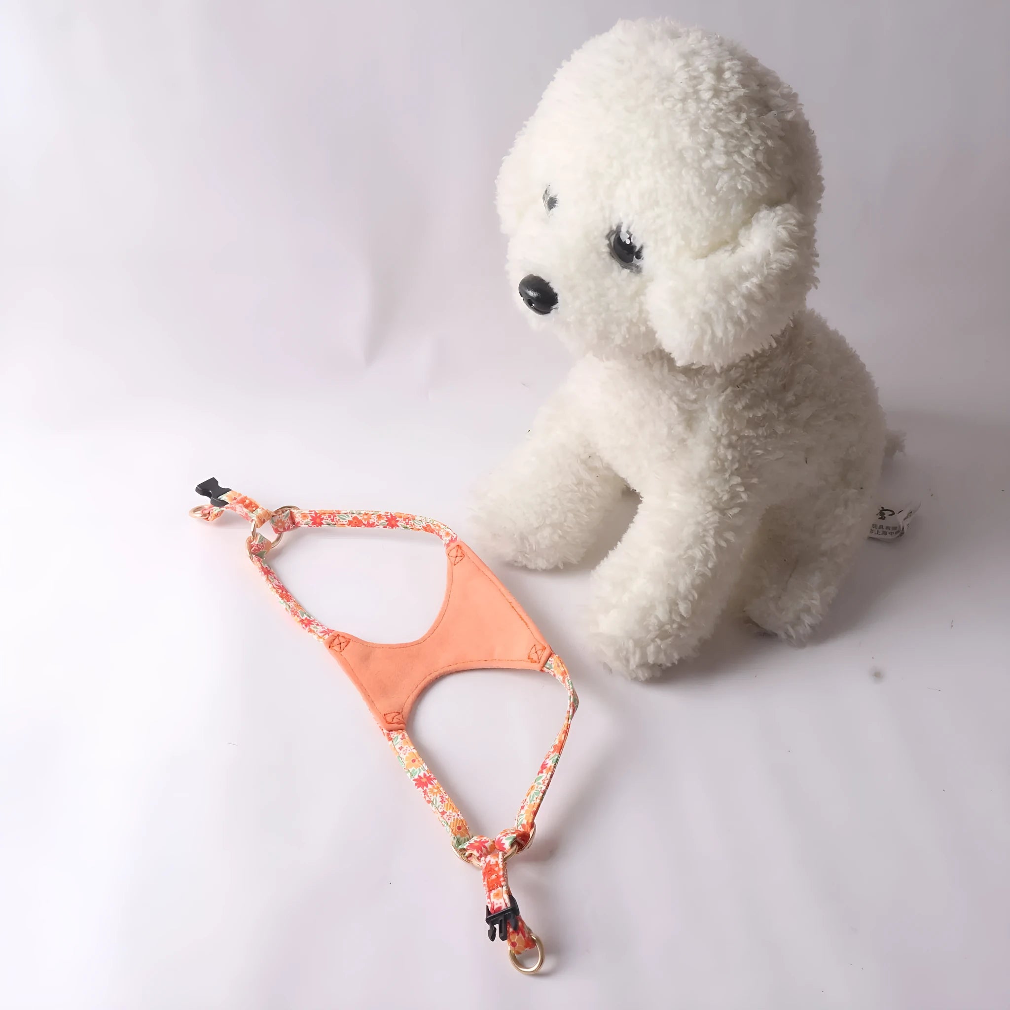 Cloth dog harness and leash set shown in various colours including a floral print, for small dogs.