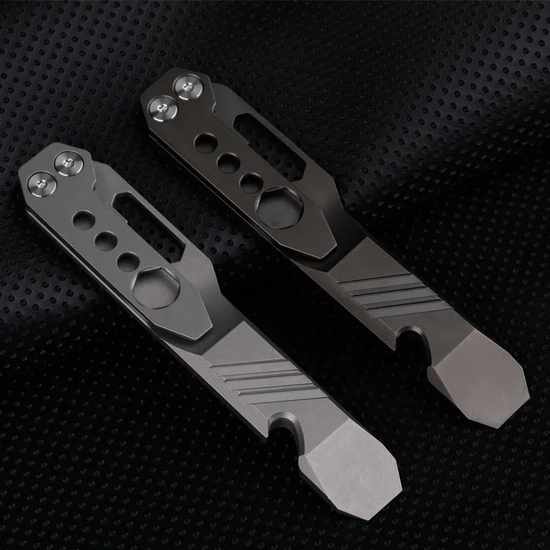 Titanium alloy multi-function crowbar tool with integrated bottle opener in gun grey or stone wash finish.