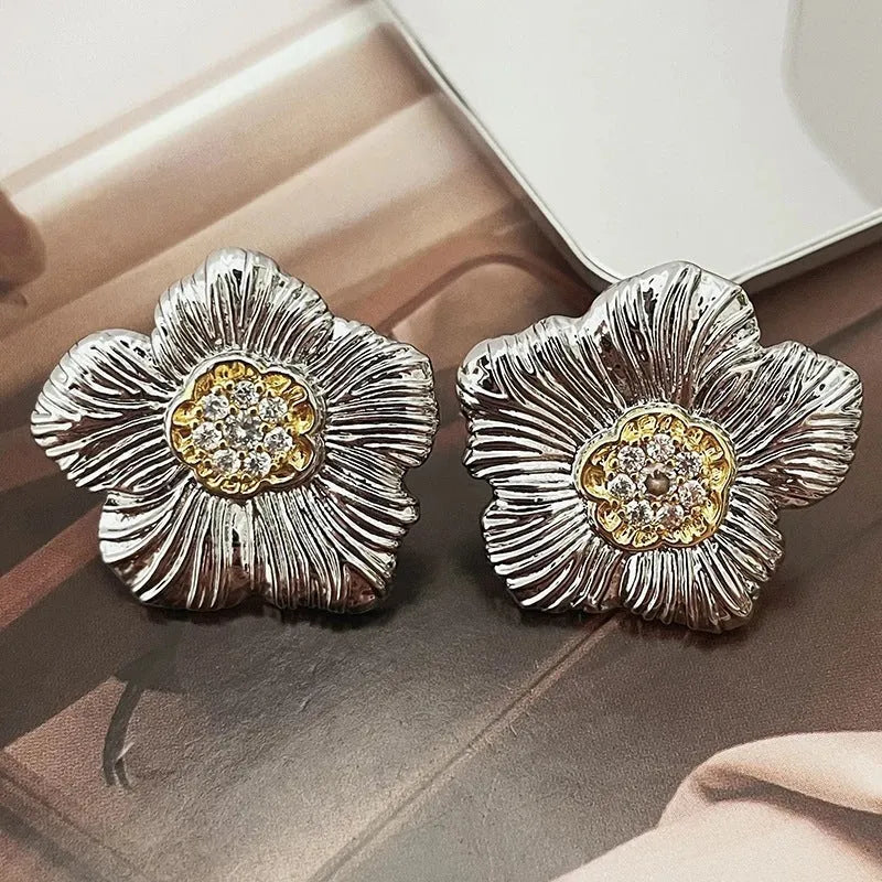 Retro textured two-tone copper stud earrings with gardenia petal motif on white background