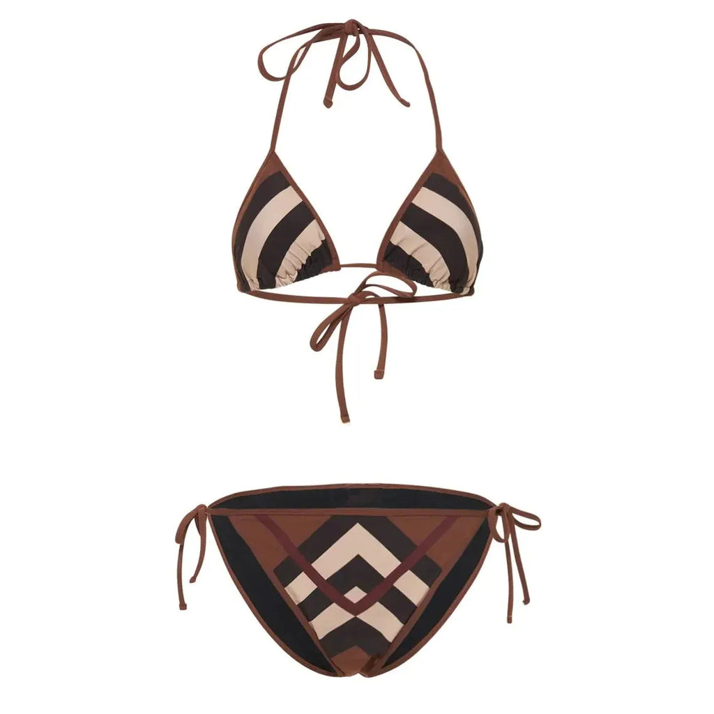 Women's black and white floral bikini set with split briefs on a beach