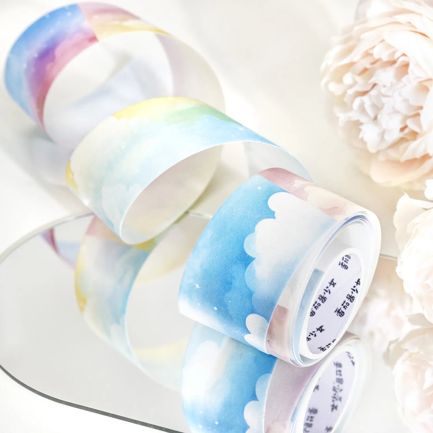 Roll of Japanese paper decorative tape with sky theme designs including clouds and nebula patterns