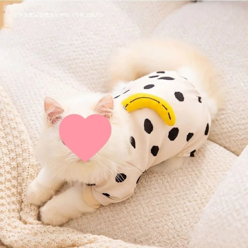 Cute kitty wearing an anti-lint Dralon pet coat in white polka dot banana design