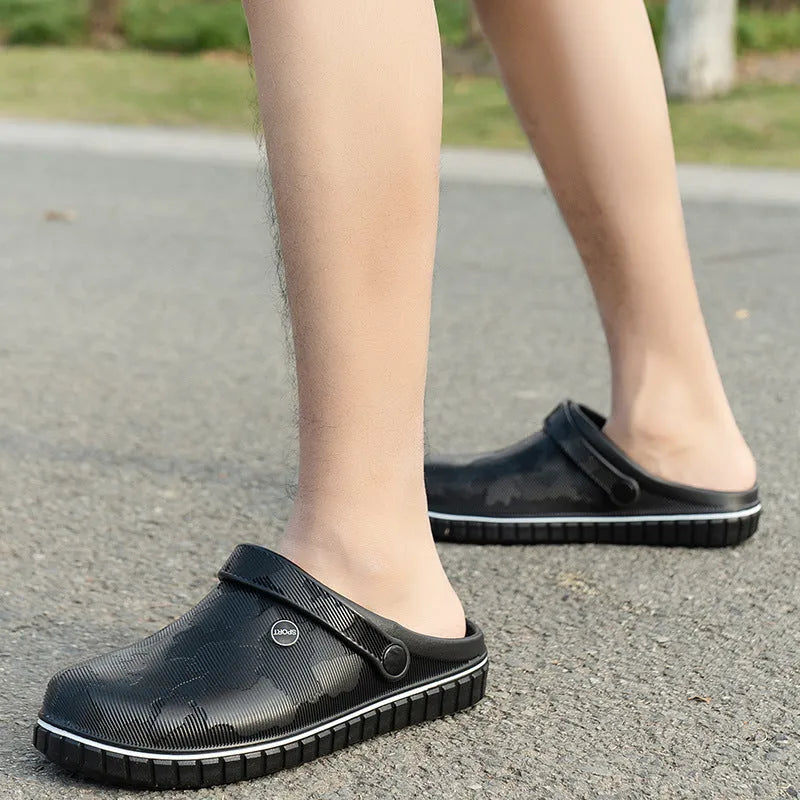 Men's casual beach sandals in black with flat heel, round toe, and EVA upper on a wooden floor