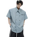 Man wearing a loose-fit blue short-sleeved casual shirt with splicing detail on the front.