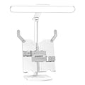 Adjustable multifunctional table lamp with an integrated bookshelf shelf on a wooden desk.