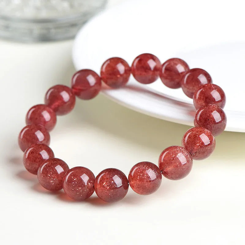 Natural strawberry quartz crystal bracelet with geometric beads showing starry inclusions