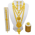 Gold women's jewellery set with tassel necklace, water wave chain, earrings, bracelet, and ring on display
