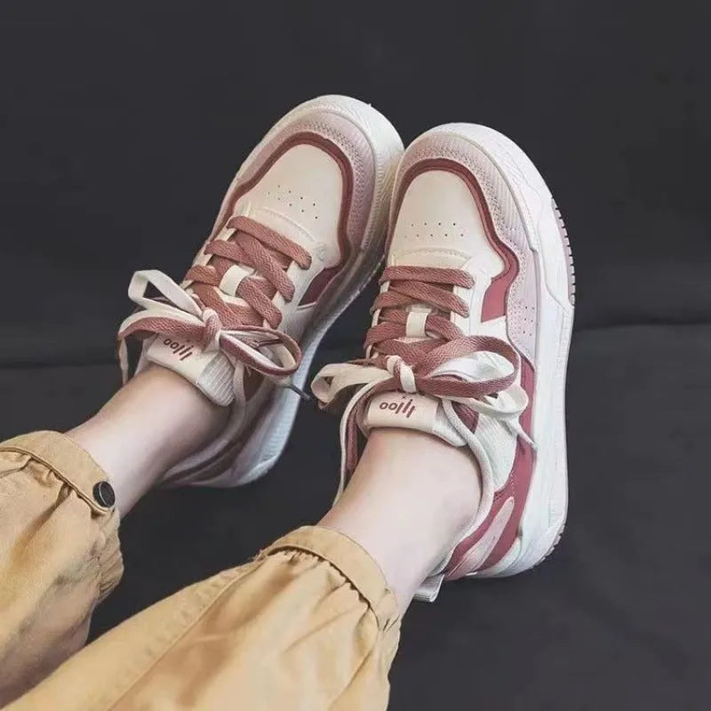 Beige and pink women's low top sneakers with a height increasing sole.