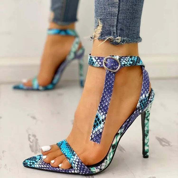 Blue women's high heels with serpentine design, hollow out details, buckle fastening, and pointed toe.