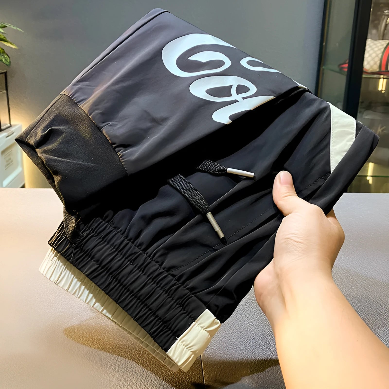 Man wearing black ultra-thin ice silk cropped trousers with elasticated ankle bands.
