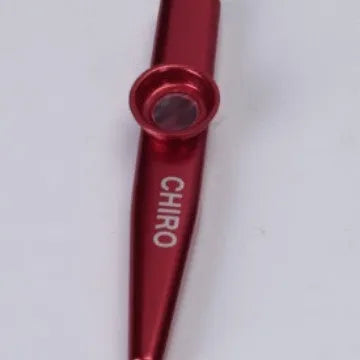 Metal kazoo in Flame Red with paper tube against a white background