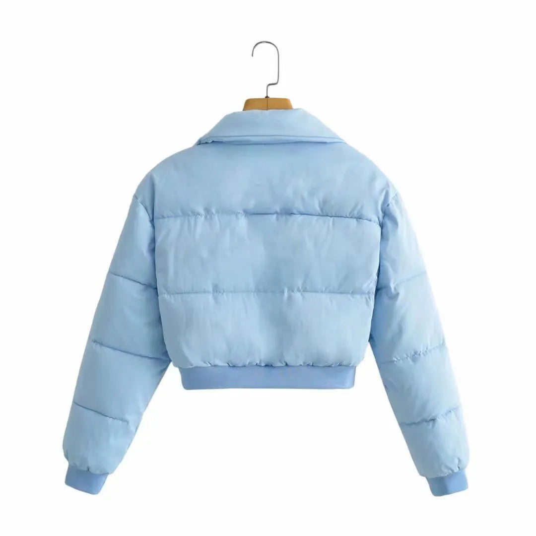 Women's loose fit long sleeve polyester jacket in blue, shown on a hanger.