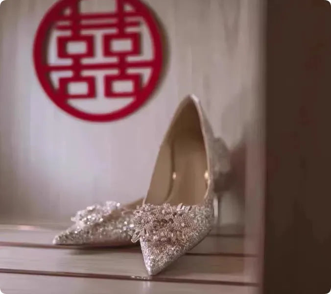 Champagne coloured pointed toe bridal shoes with rhinestone decoration on a fine heel.