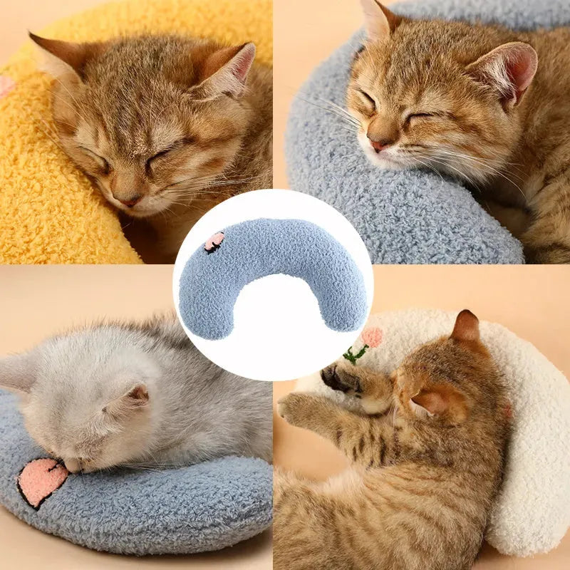 Small blue U-shaped pet pillow with faux fur, showing raised rim and half-donut shape for cats or small dogs.