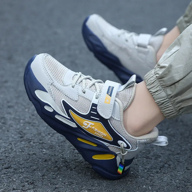 Boys dark blue and beige sports running shoes with Velcro strap and mesh upper.