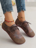 Flat retro soft leather western style slip-on loafers in black, round toe, low heel, belt decoration