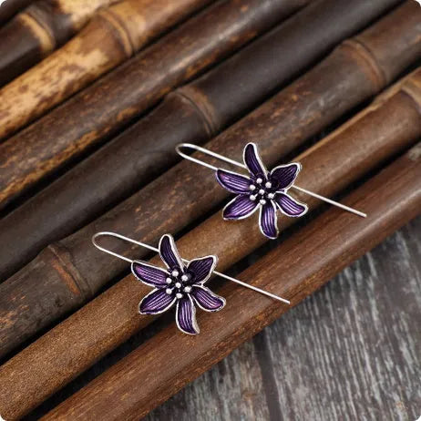 Pair of purple retro-style flower-shaped alloy earrings for women.