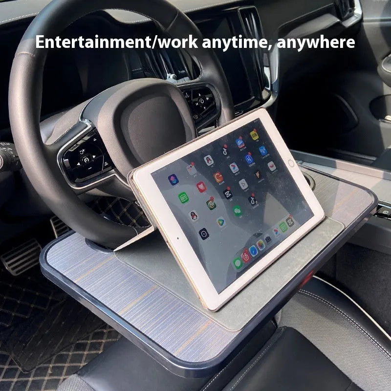 Black car steering wheel laptop tray with foldable cup holder on a 42cm by 28cm surface.