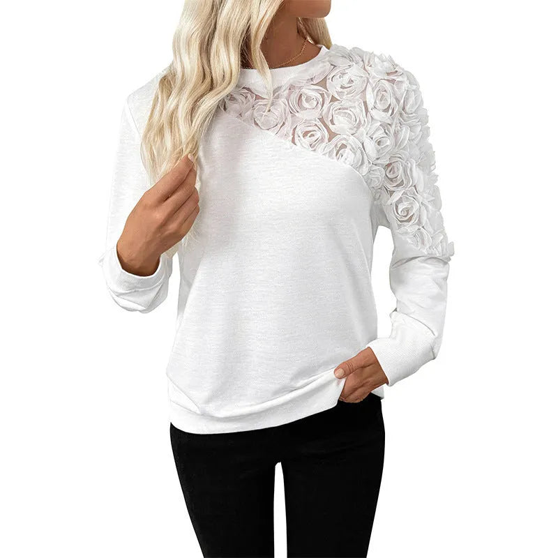 White floral patterned long sleeve women's pullover top with a loose fit.