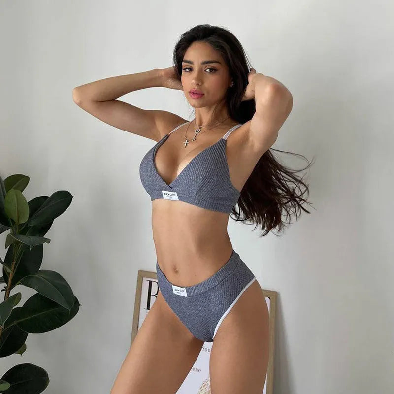 Women's grey bikini set with embroidery detail and contrast colour binding on a shorts-length bottom.
