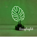 White bamboo-shaped desktop lamp emitting green light with USB power cable