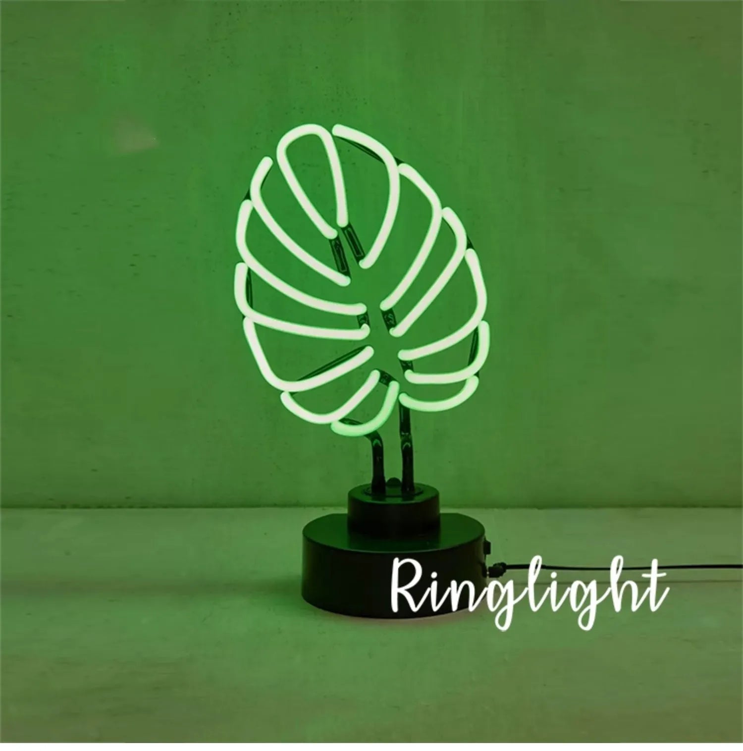 White bamboo-shaped desktop lamp emitting green light with USB power cable